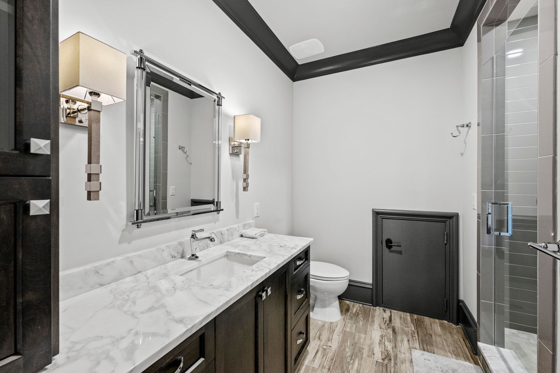 a bathroom with a toilet a sink and a mirror | Charlotte, NC | Harland Building Group 