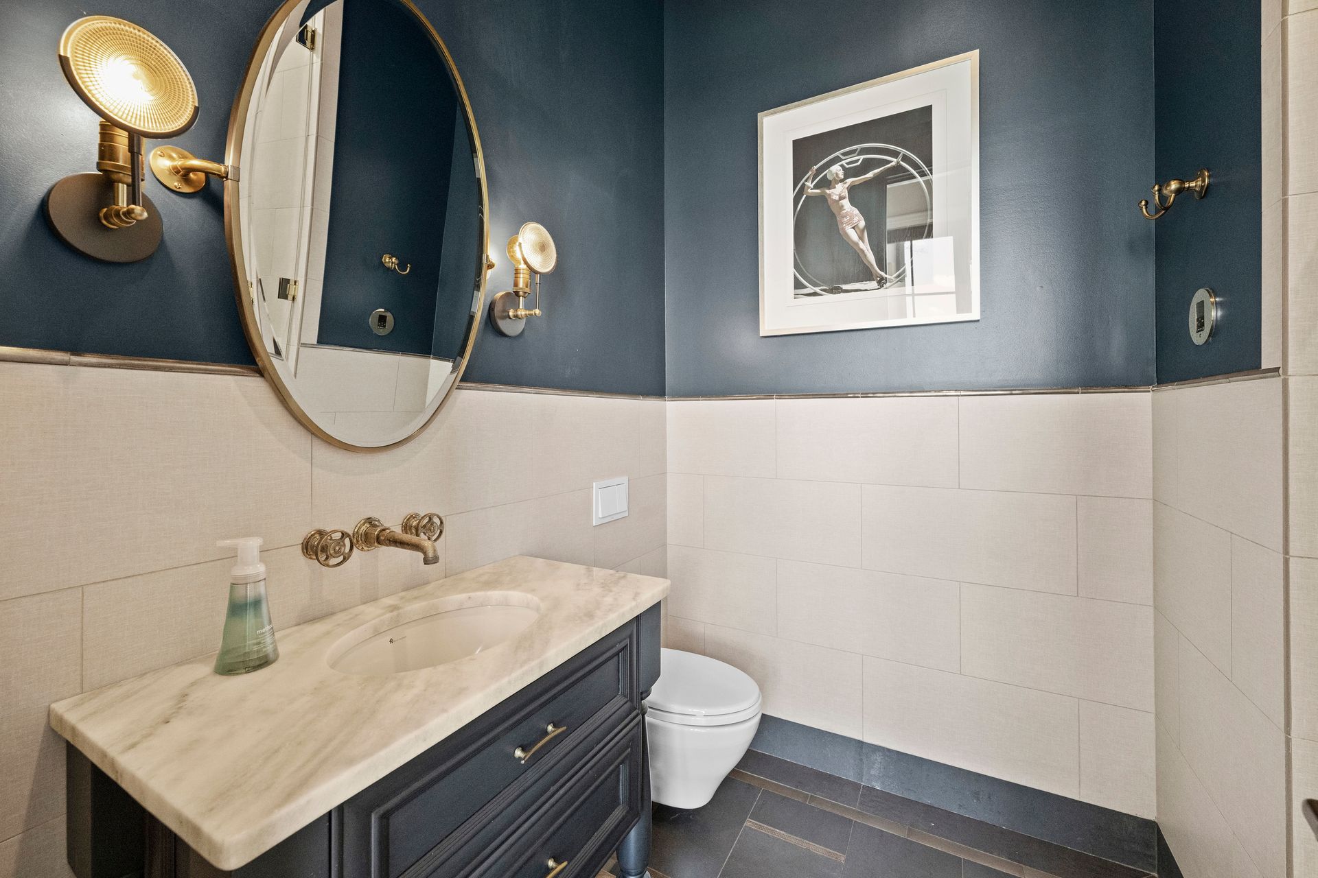 a bathroom with a picture on the wall above the toilet | Charlotte, NC | Harland Building Group 