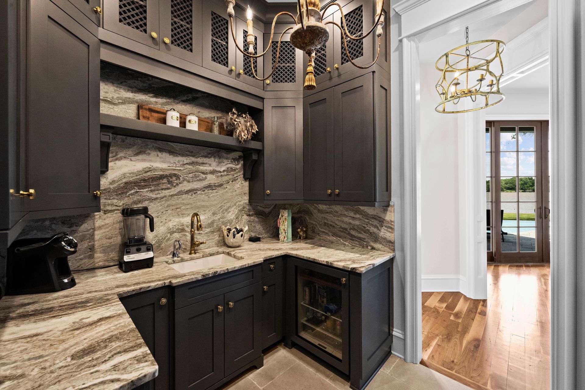 a kitchen with black cabinets and marble counter tops | Charlotte, NC | Harland Building Group 