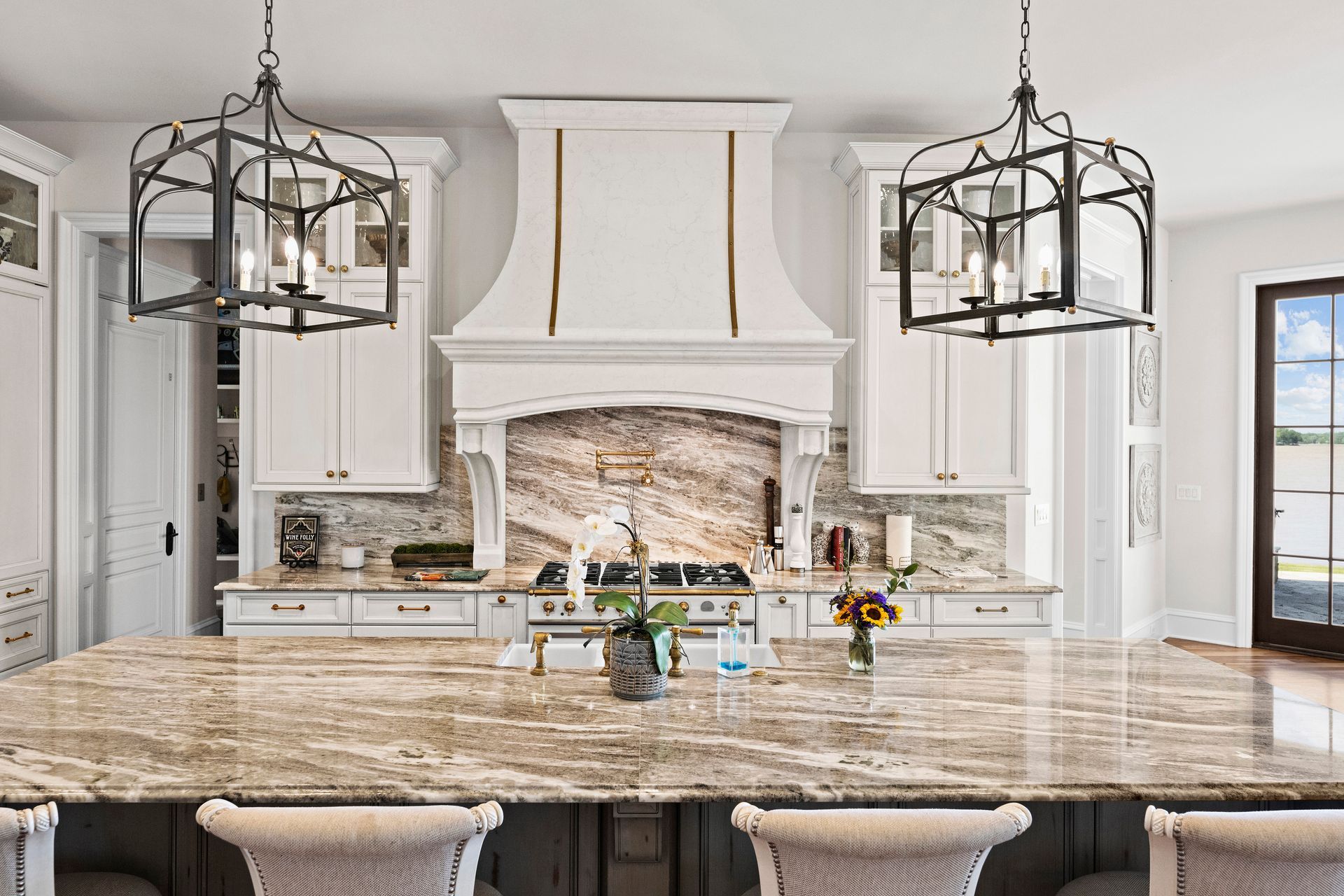 a kitchen with white cabinets and marble counter tops | Charlotte, NC | Harland Building Group 
