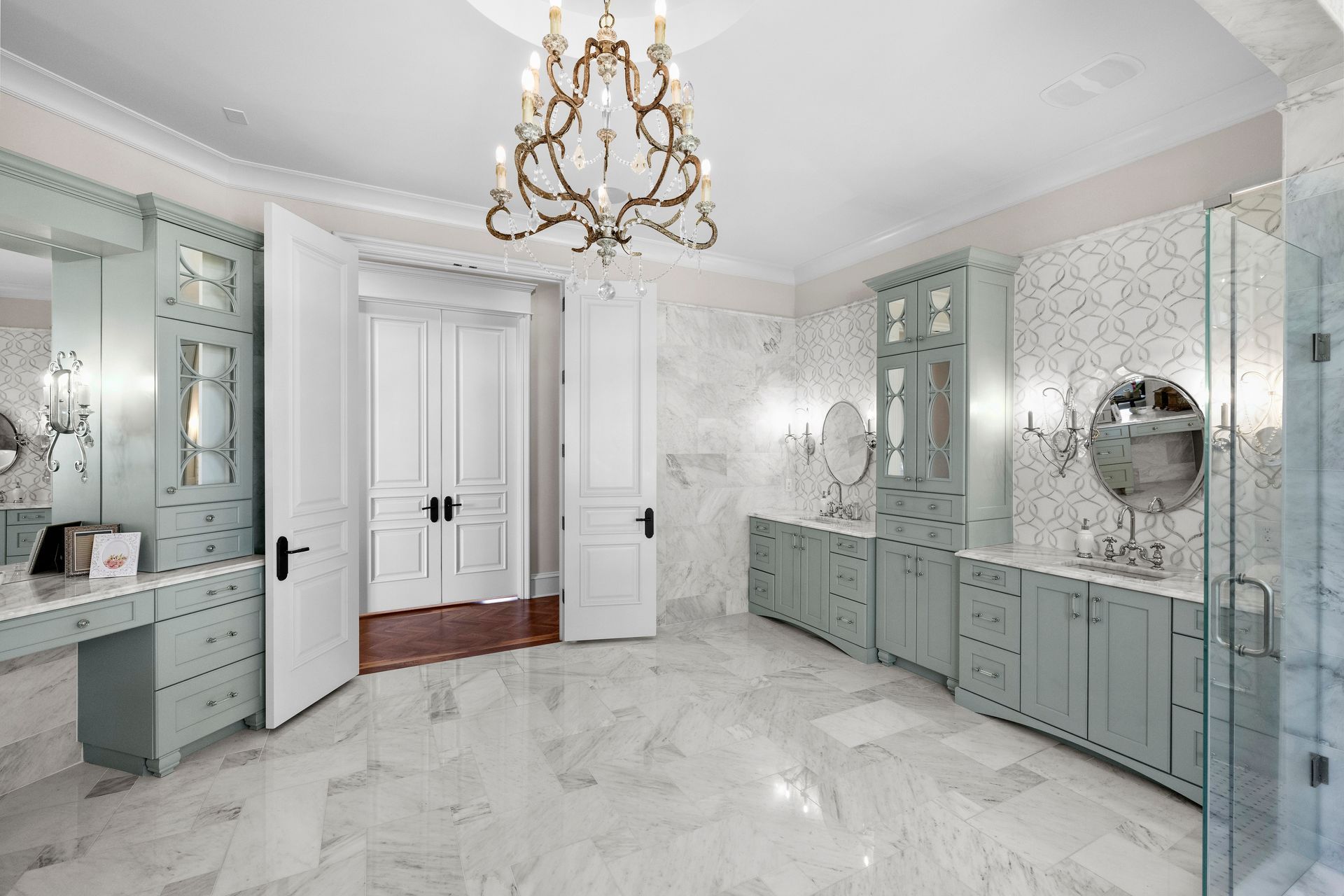 a bathroom with a chandelier hanging from the ceiling | Charlotte, NC | Harland Building Group 