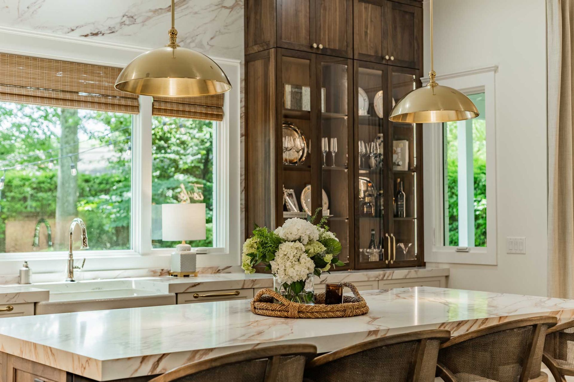 A kitchen with a large island and a marble counter top.