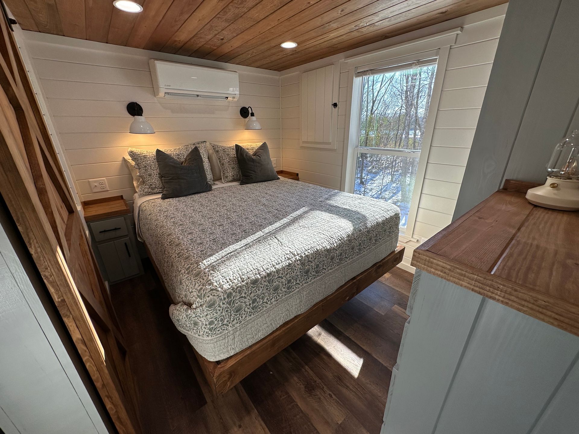 A bedroom with a large bed and a window.
