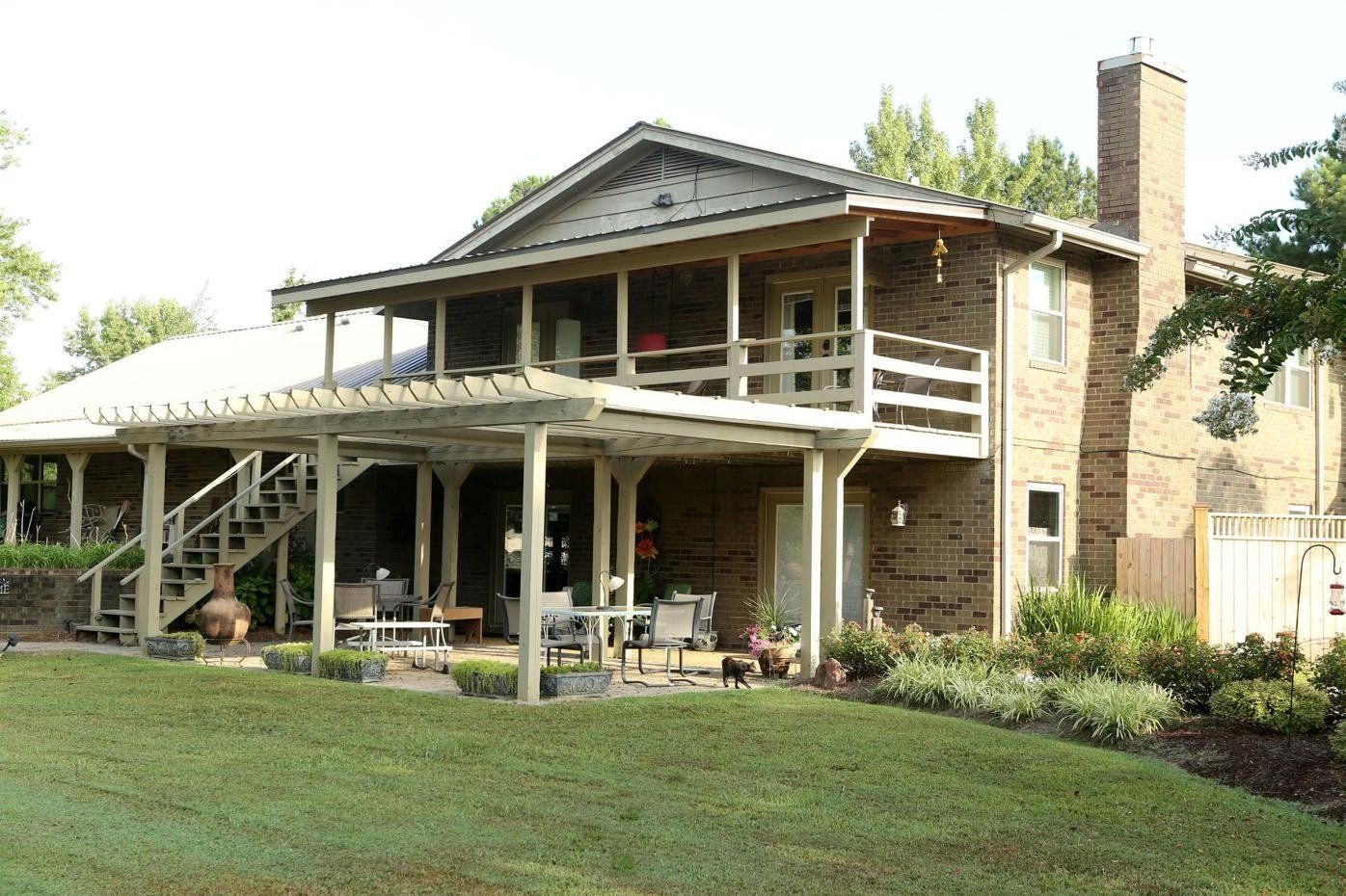 A large brick house with a porch and stairs
