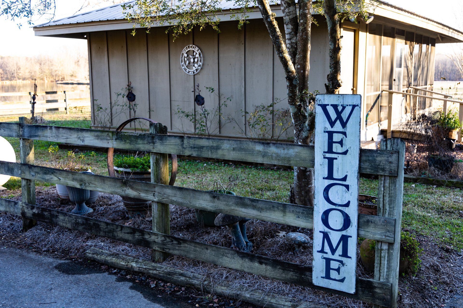A wooden fence with a welcome sign on it