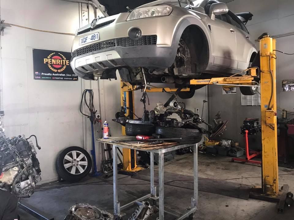 Car On A Hoist With No Wheels Getting Brake Repairs