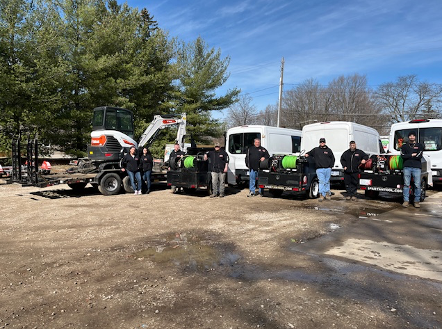 Vince's team with water jetting equipment, service trucks and backhoe.