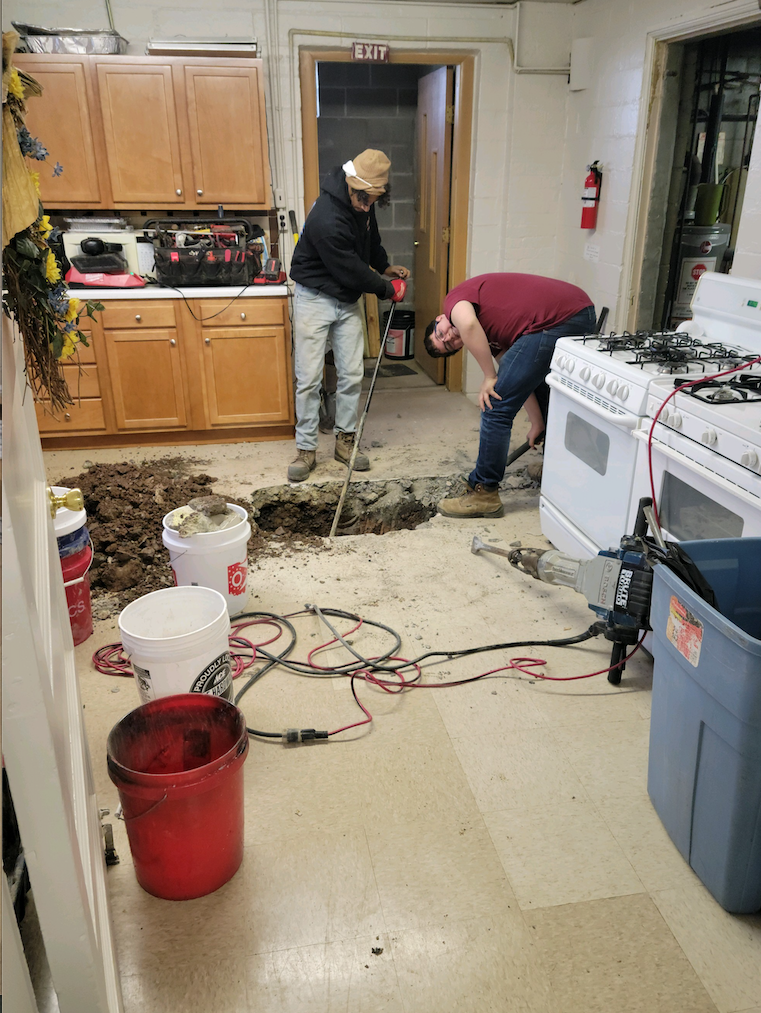 Men installing new sewer line.