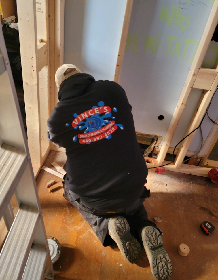Worker installing plumbing