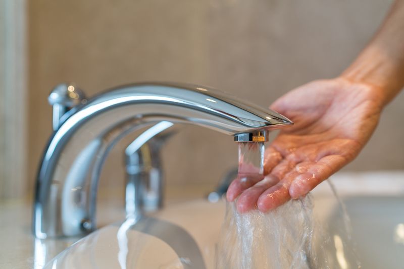 Water Temp being checked coming out of hot water faucet