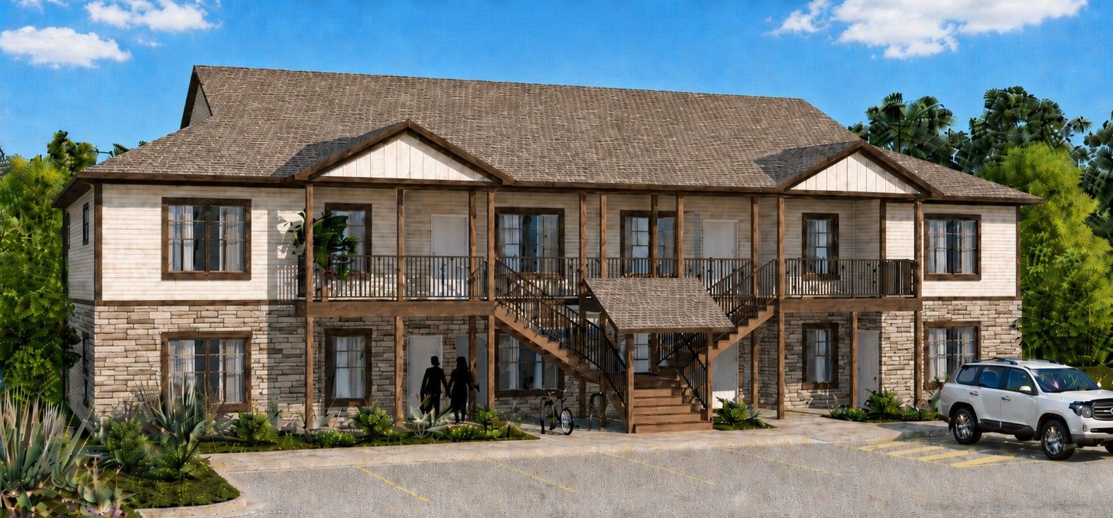 Two-story stone apartment building with exterior staircases, balconies, and parked cars in front