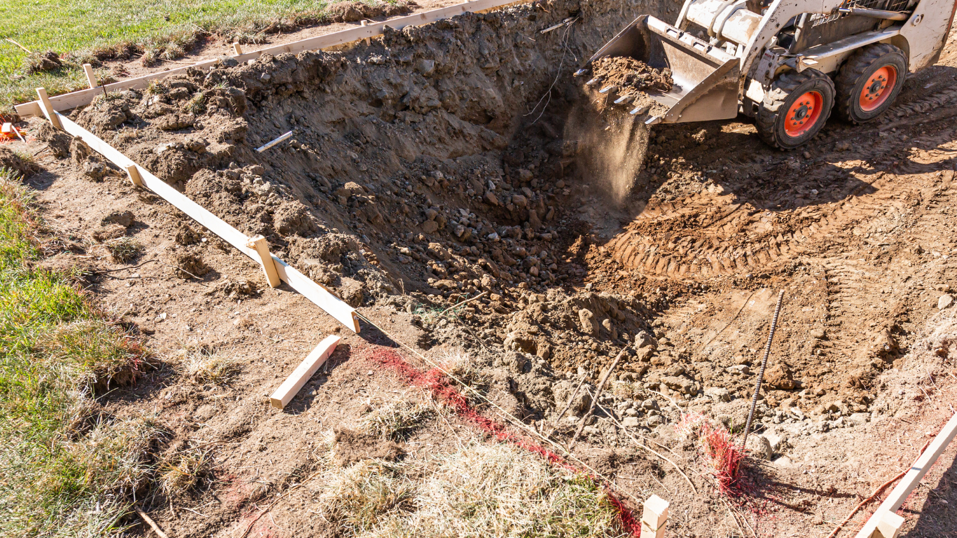 a bobcat is digging a hole in the ground