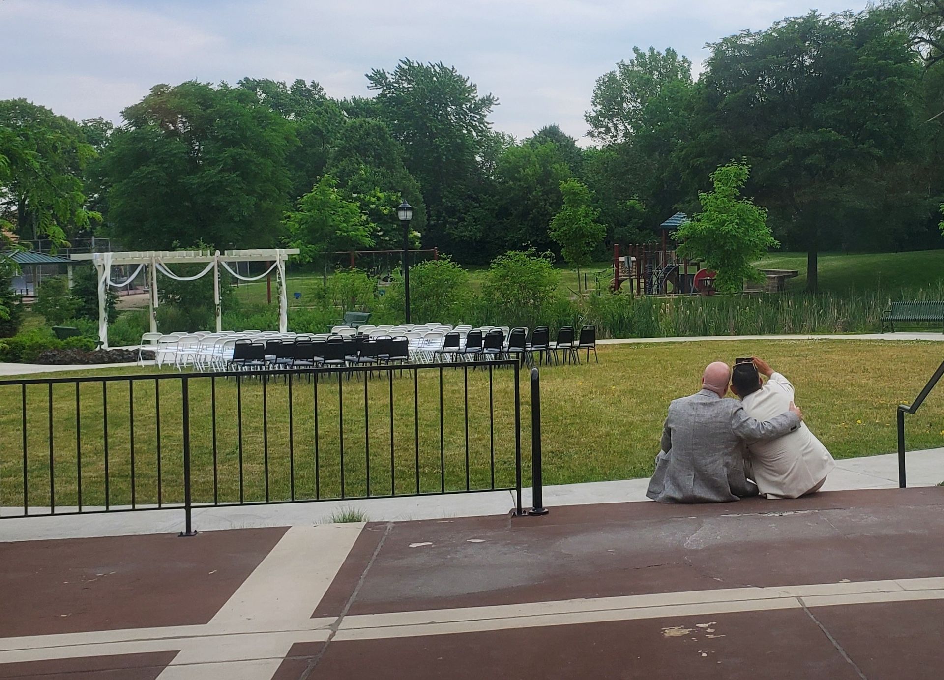A man and a woman are hugging each other in a park