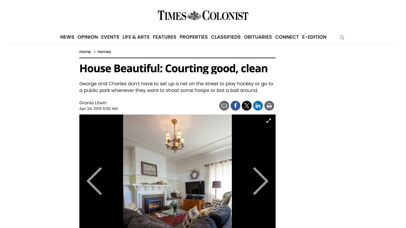 A living room with a fireplace and a chandelier on the times colonist website.