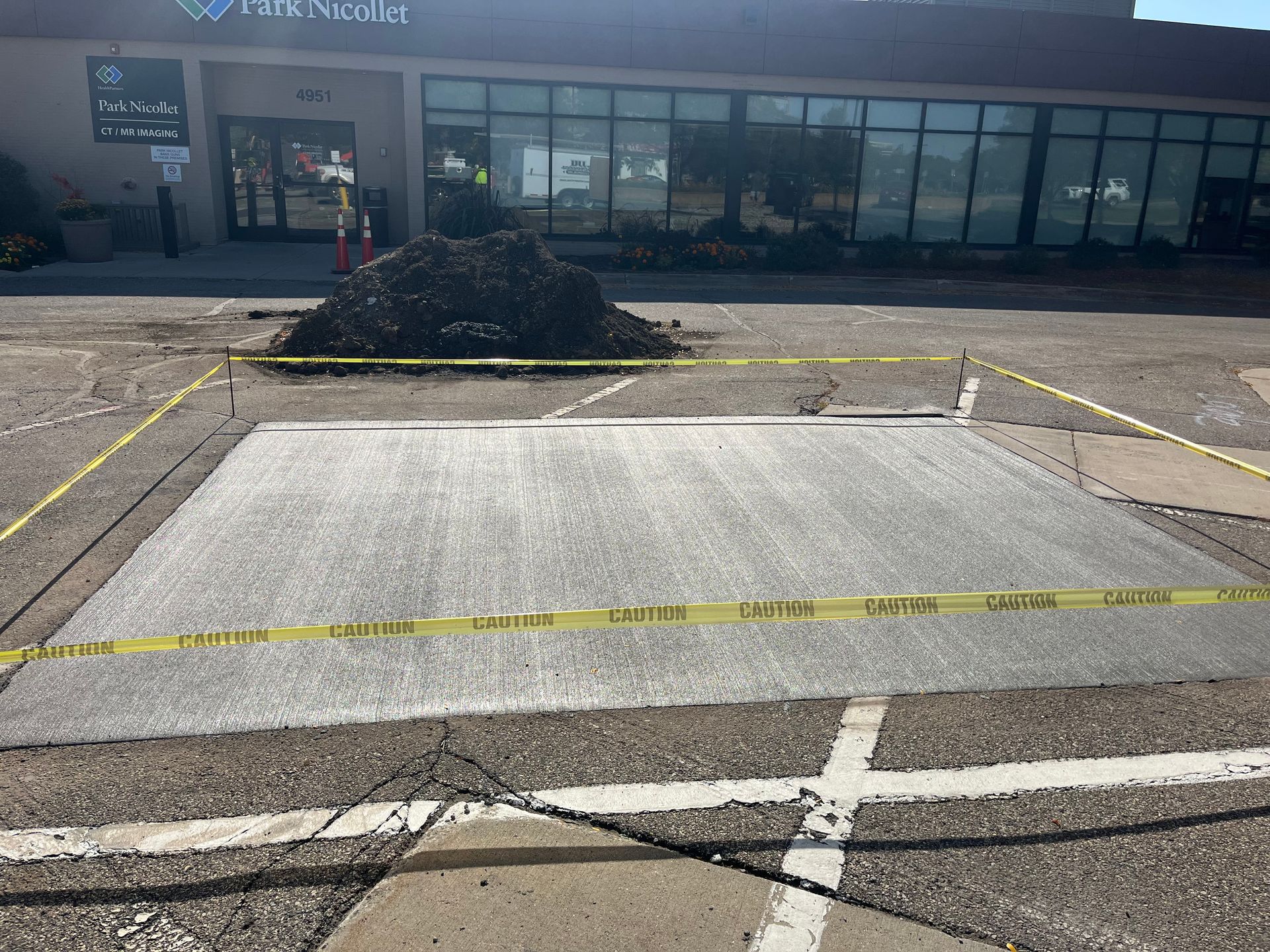 A large concrete slab is sitting in front of a building.