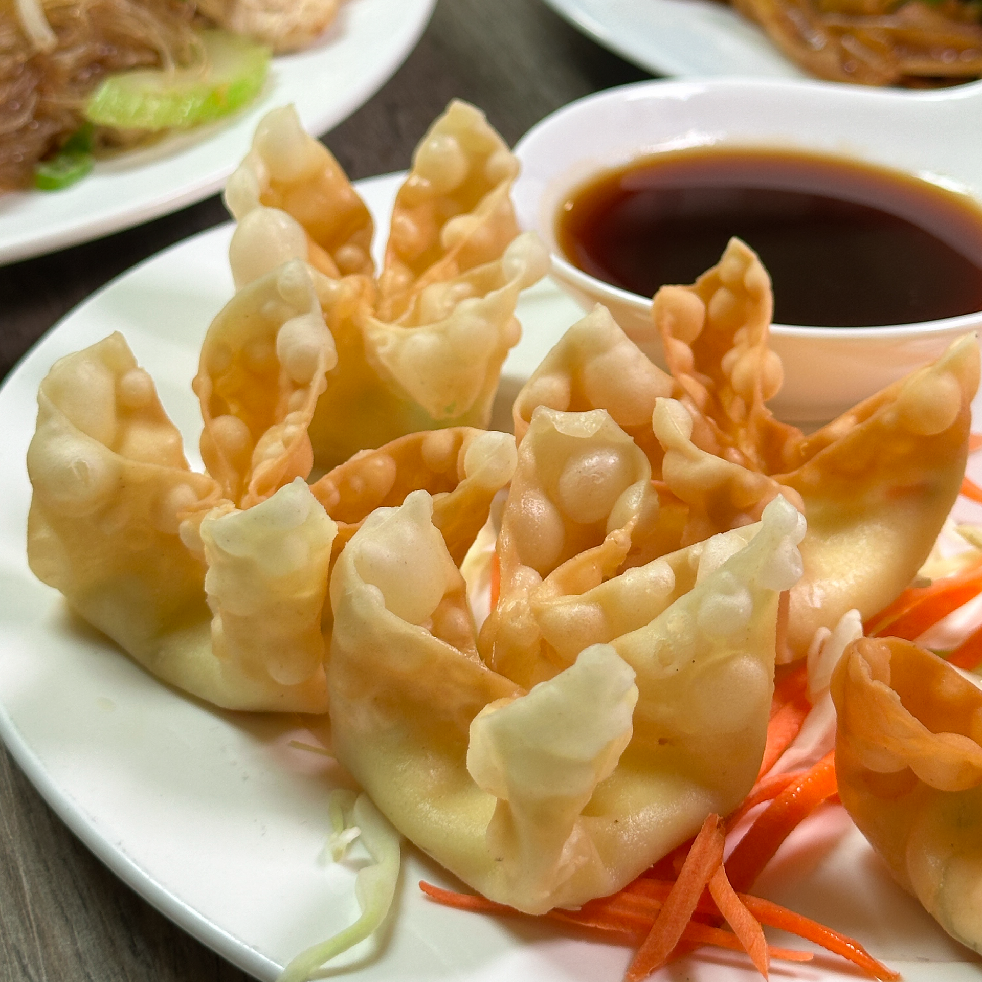 A plate of food with a bowl of dipping sauce