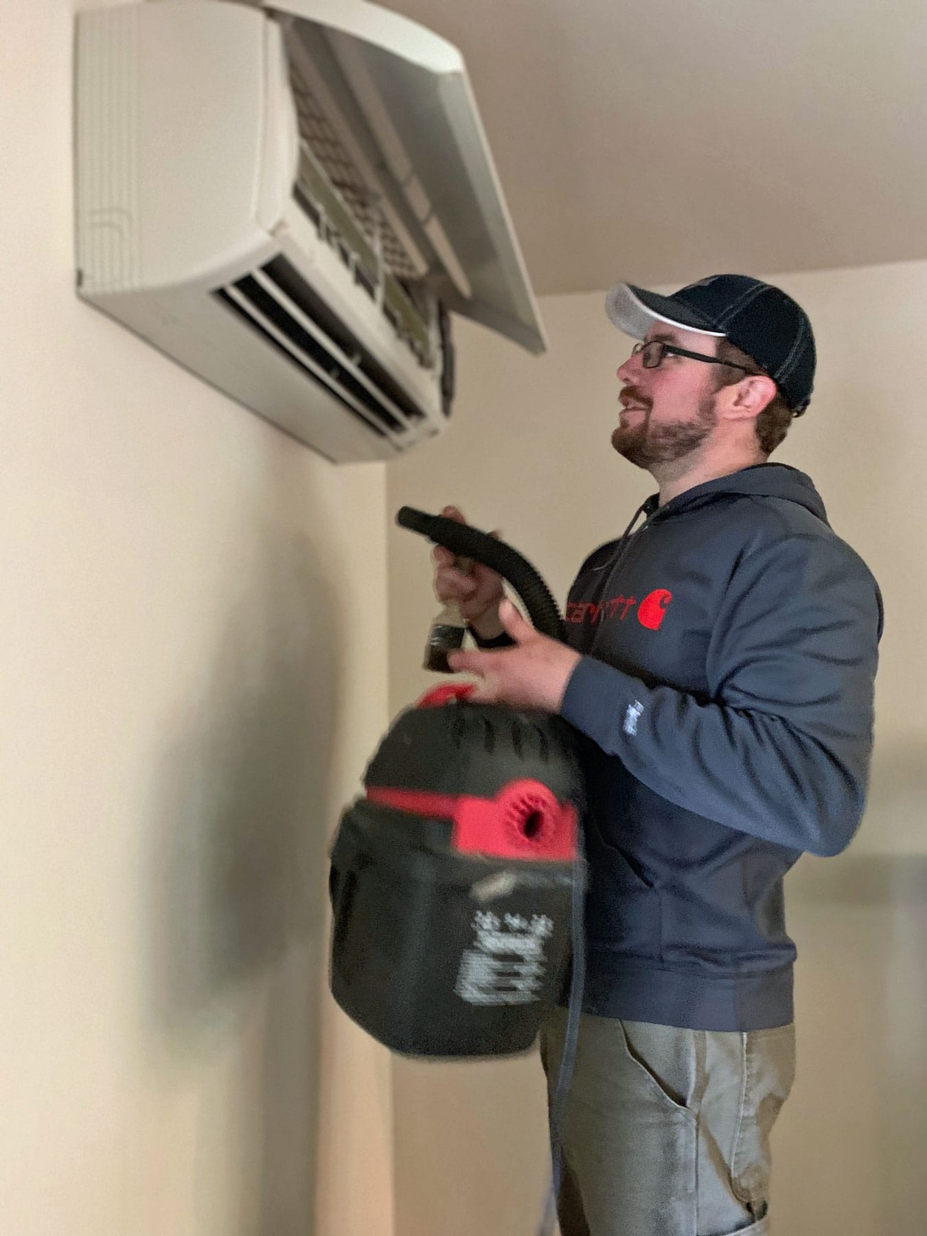 Photo of a technician installing a ductless system