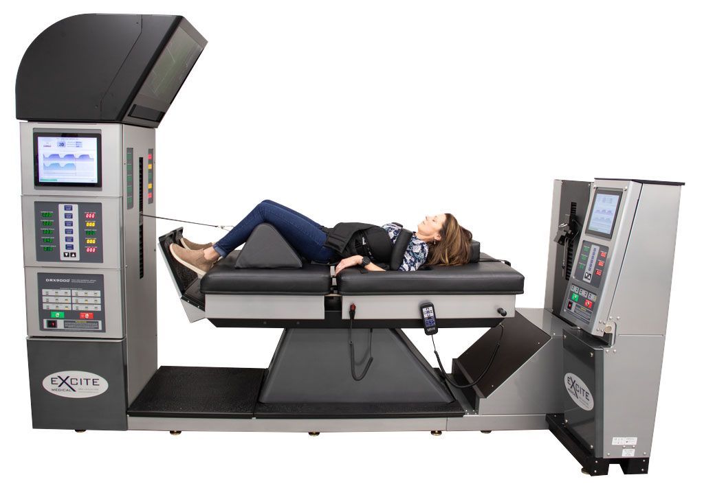 Woman lying on a medical scanning table between two upright imaging machines