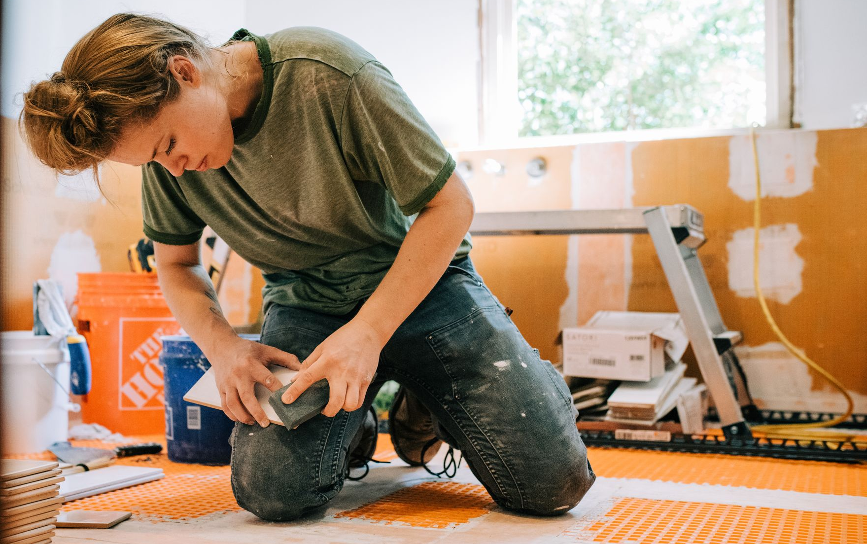 Kraus-Remodeling-woman-tiling-a-Schluter-bathroom-Northern-VA-Haymarket-Gainesville-Warrenton-Bristow-Nokesville-Centreville