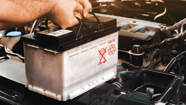 a mechanic changing a car battery