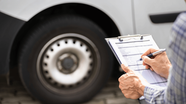 a man doing a pre-purchase inspection on a truck