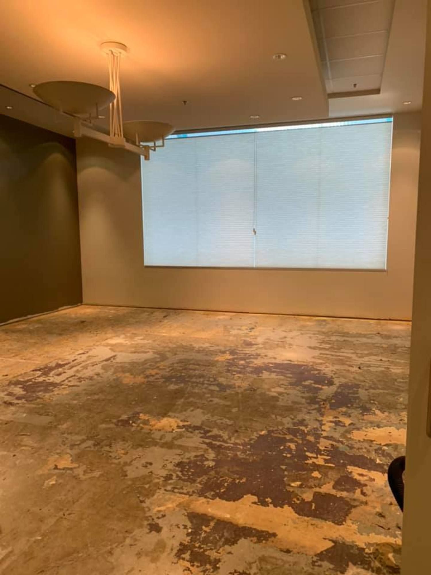 Pre-cleaning view of post-construction room with exposed concrete floor