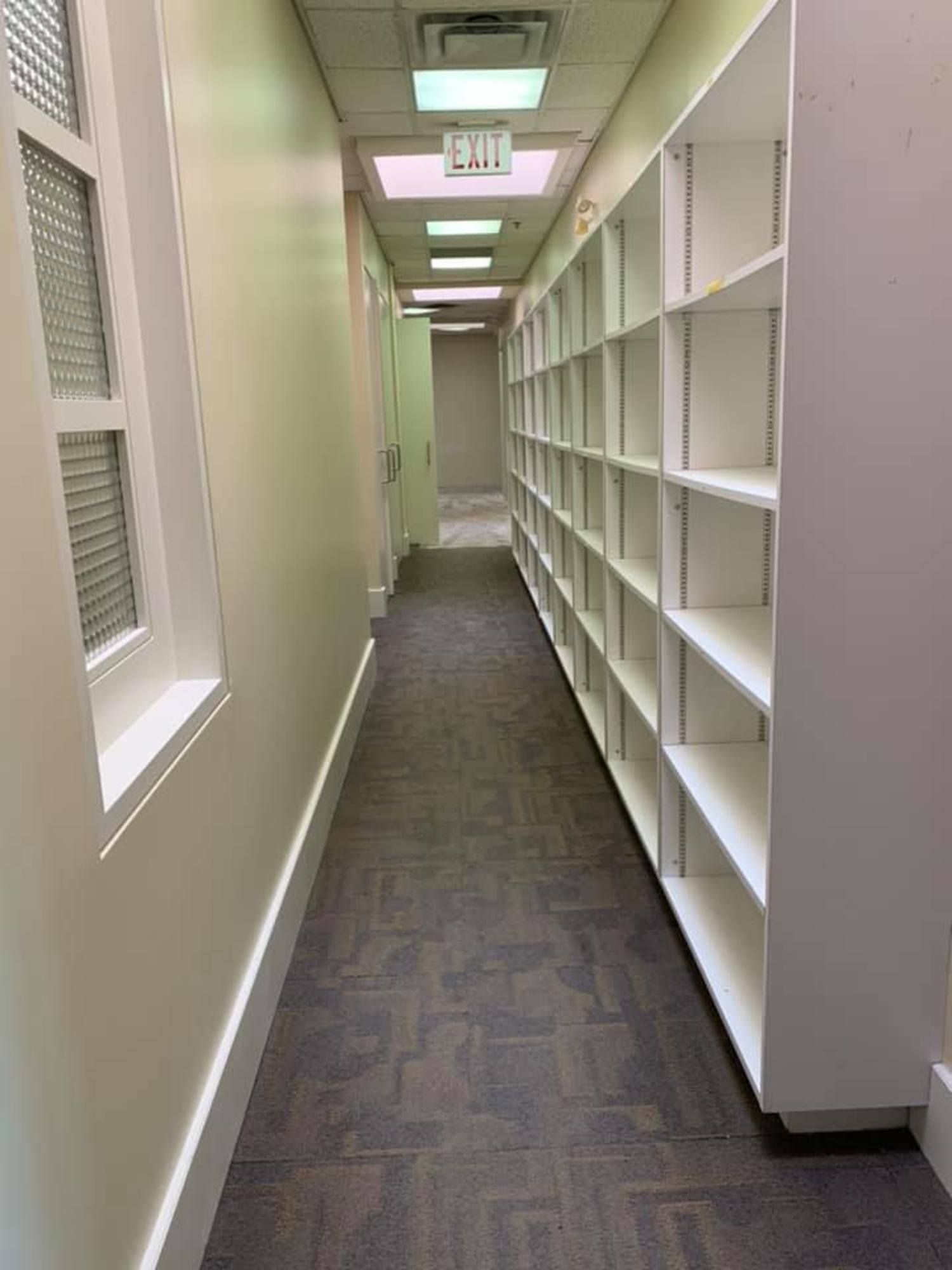 Clean hallway with built-in shelving after office cleaning services