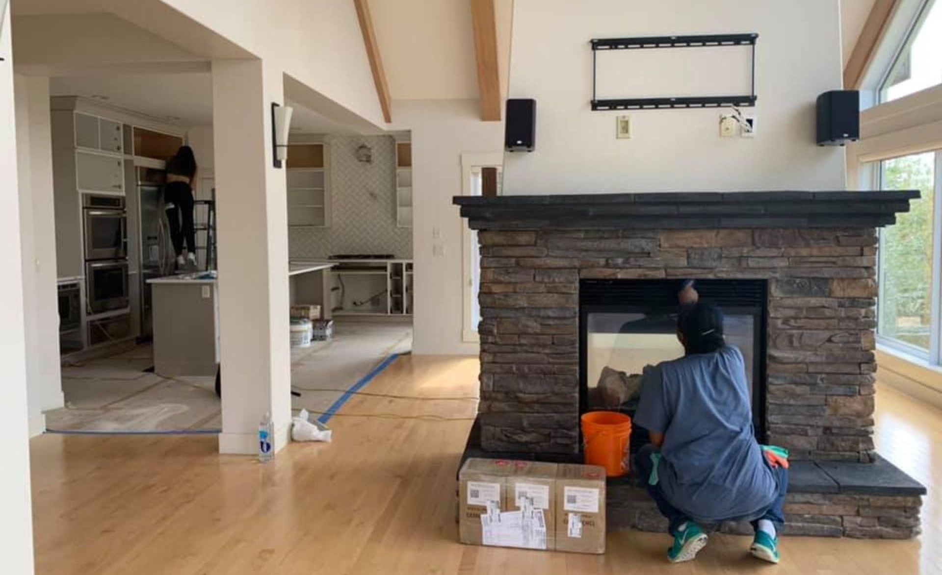Residential post-construction deep cleaning of kitchen and fireplace in progress