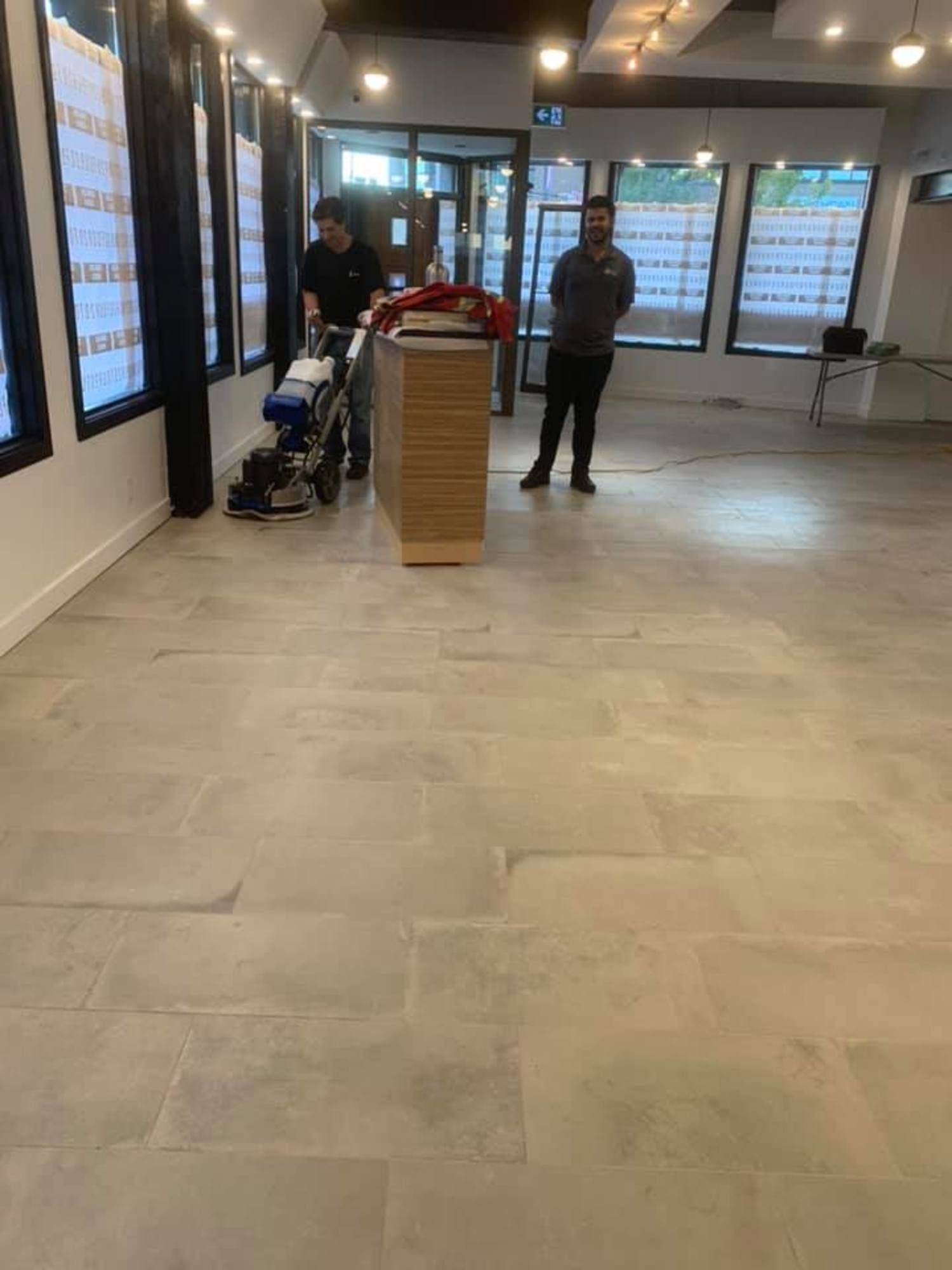 Commercial tile floor polishing and cleaning by professional crew in retail unit