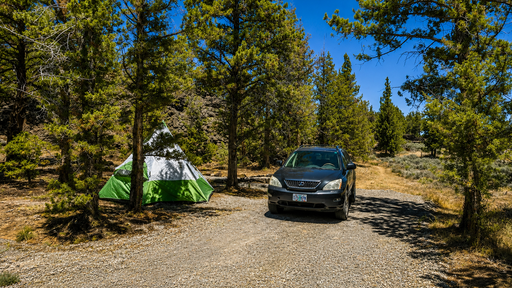 Dry RV and tent campsite among juniper trees at Roadhouse Ranch & Camp near Bend, Oregon.