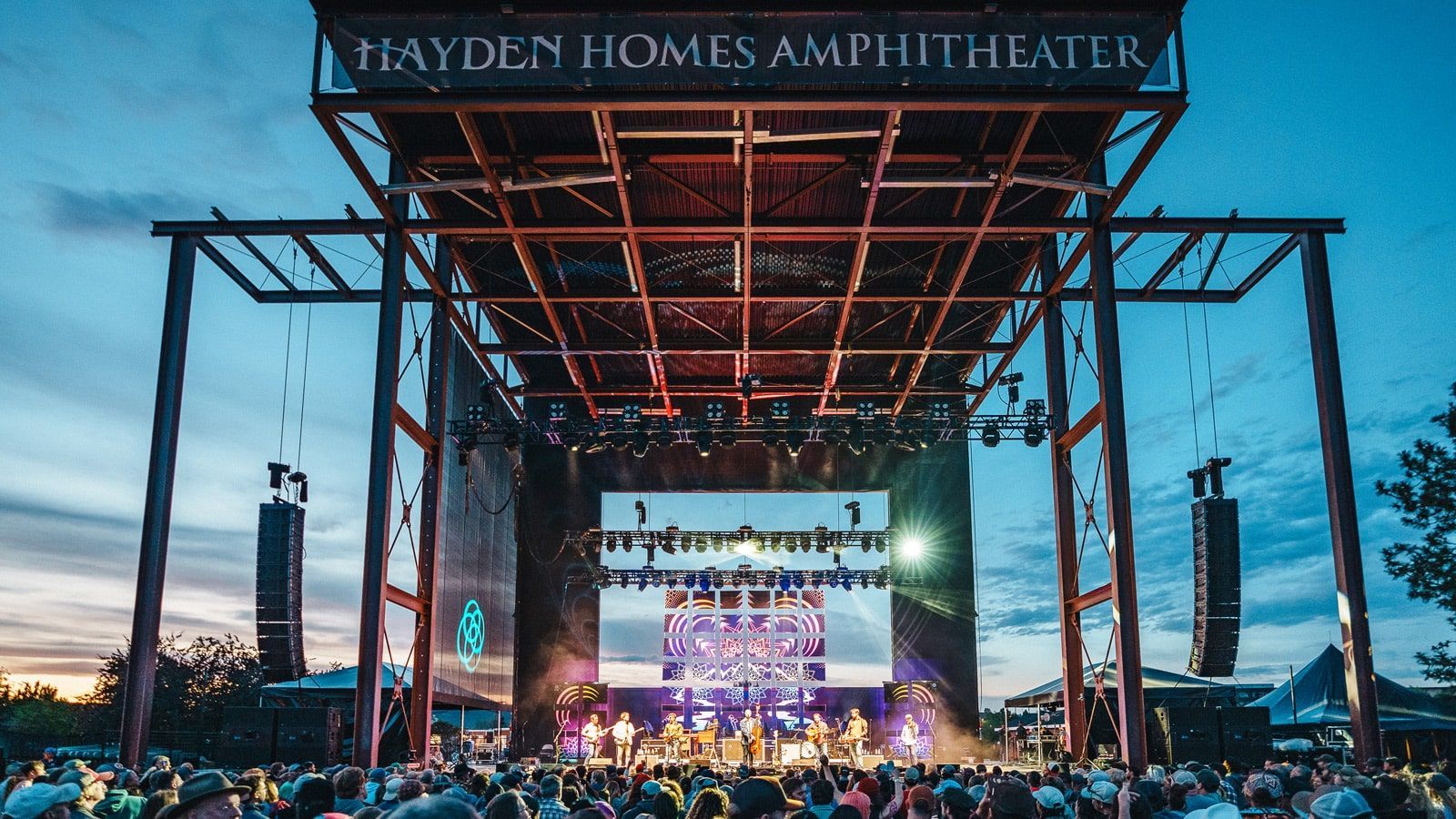 Furnished yurt among juniper trees at Roadhouse Ranch & Camp, a Bend concert base near Hayden Homes Amphitheater.