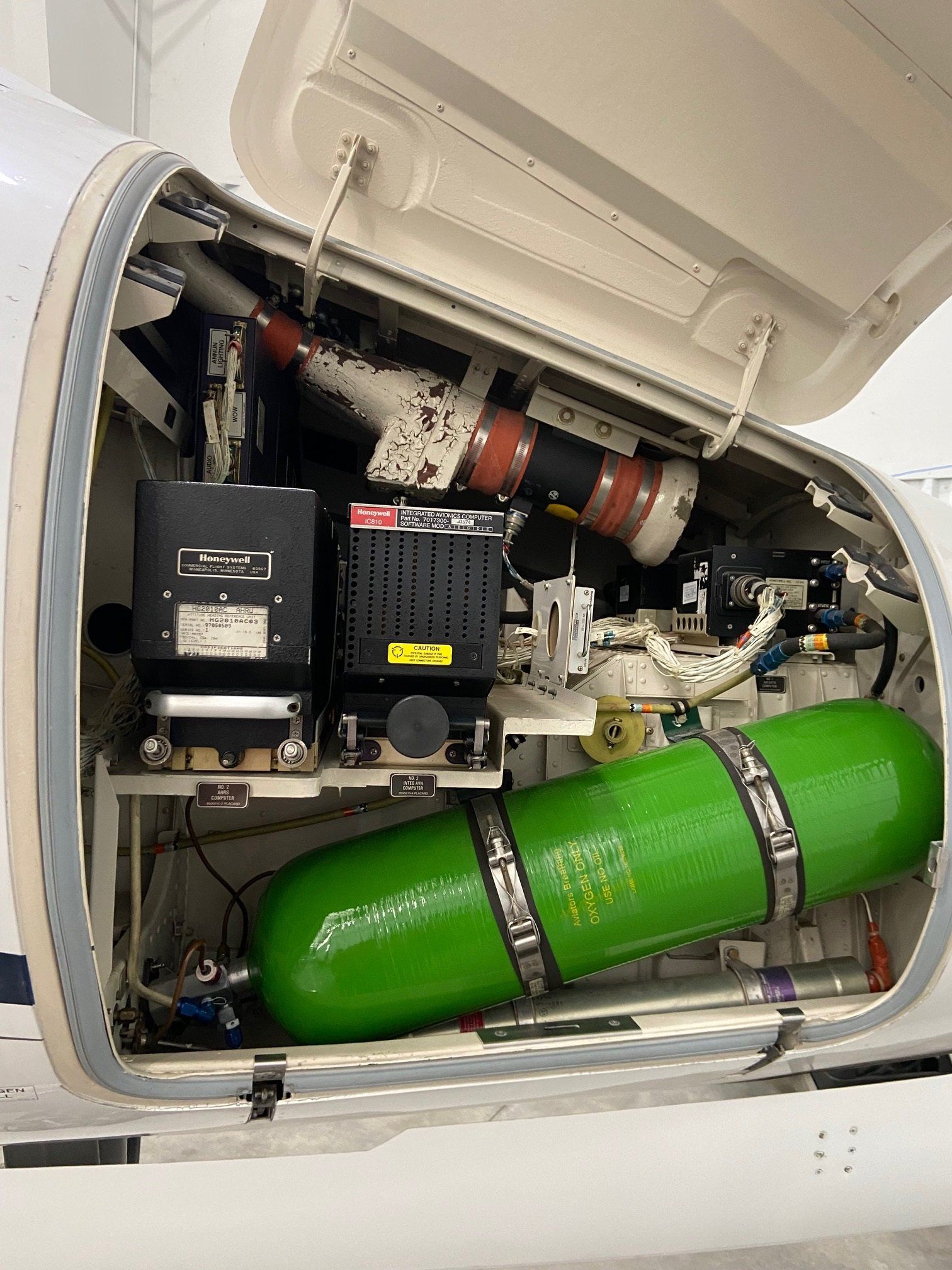 A white airplane with a green cylinder in the back