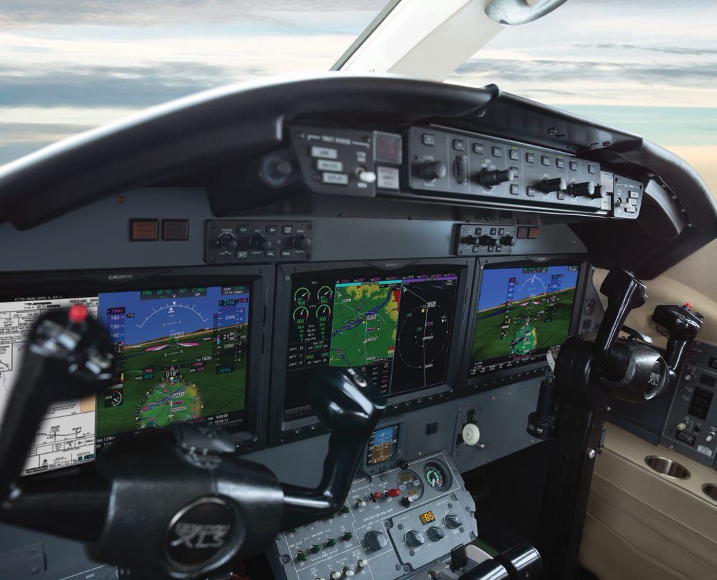 A cockpit of an airplane with the letters rtf on the steering wheel