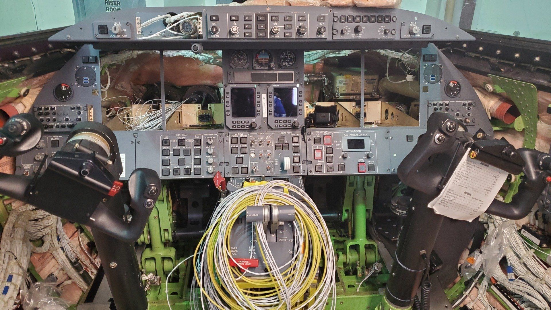 A cockpit of an airplane with a clock on it