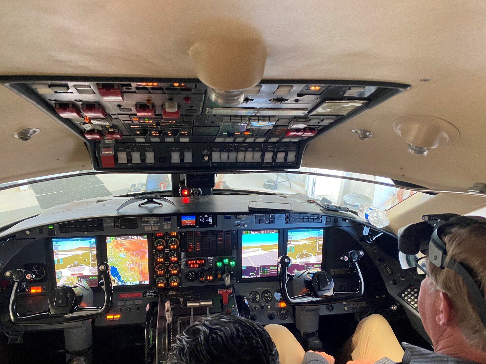 A man is sitting in the cockpit of an airplane