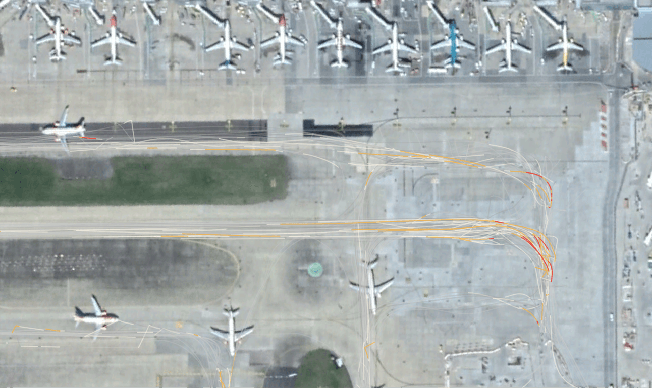 An aerial view of an airport with planes parked on the tarmac