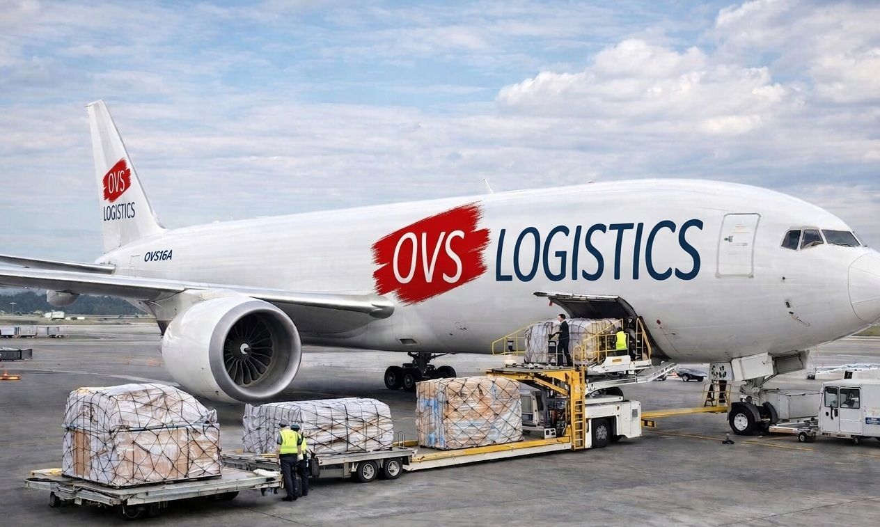Cargo plane with OVS Logistics logo being loaded with freight containers on the tarmac