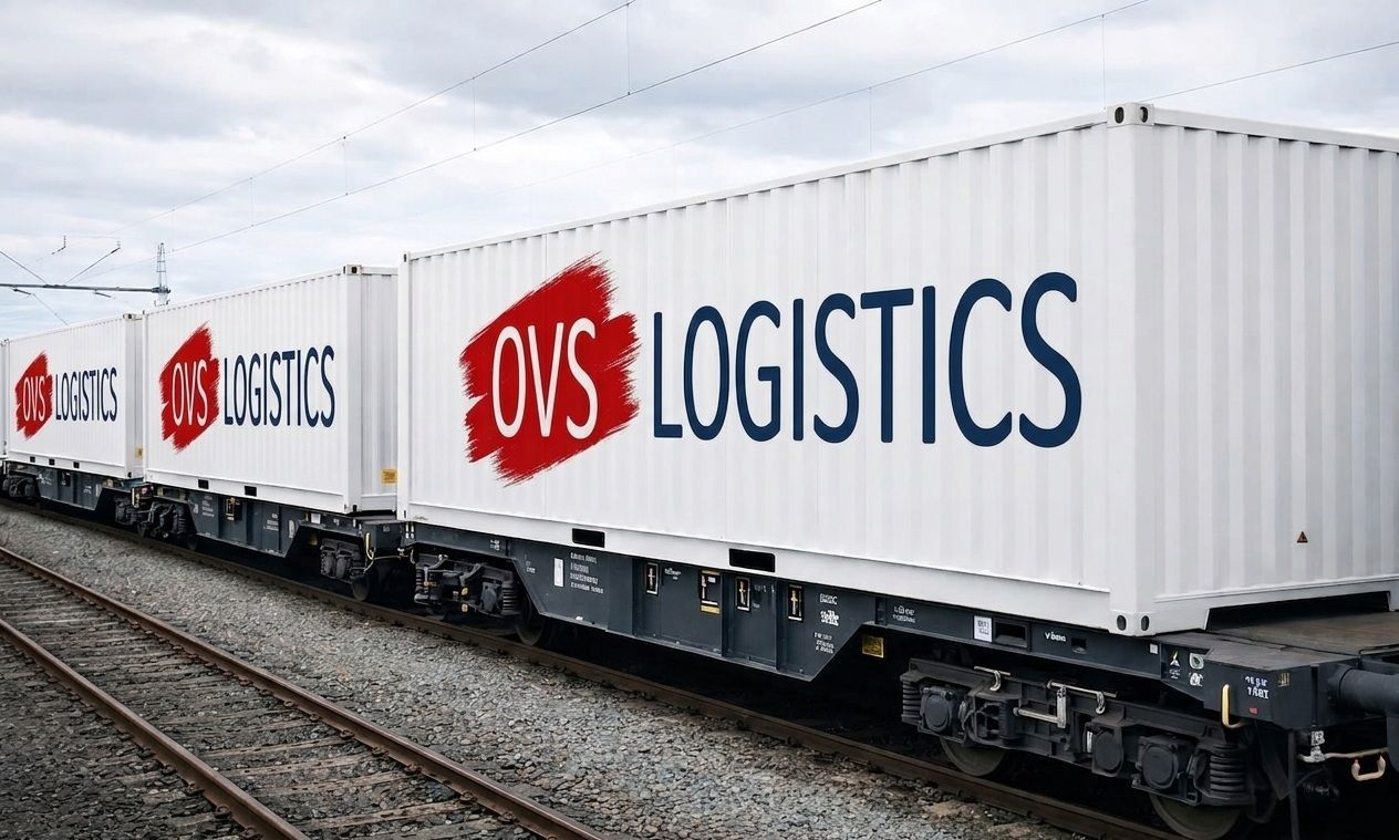 White AWS Logistics freight train containers on tracks under cloudy sky