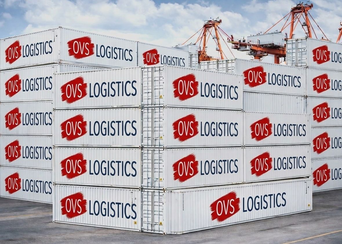 Stacks of white OVLS Logistics shipping containers at a port with cranes in the background