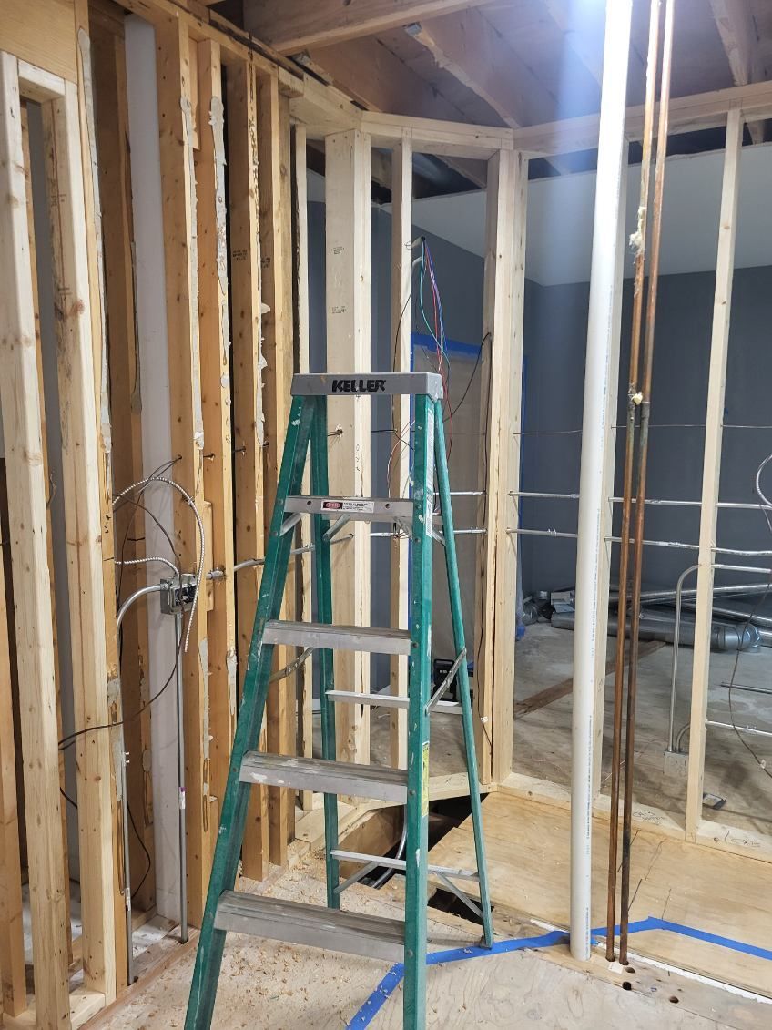 Interior framing and electrical rough-in work during a residential remodel project by N Electric