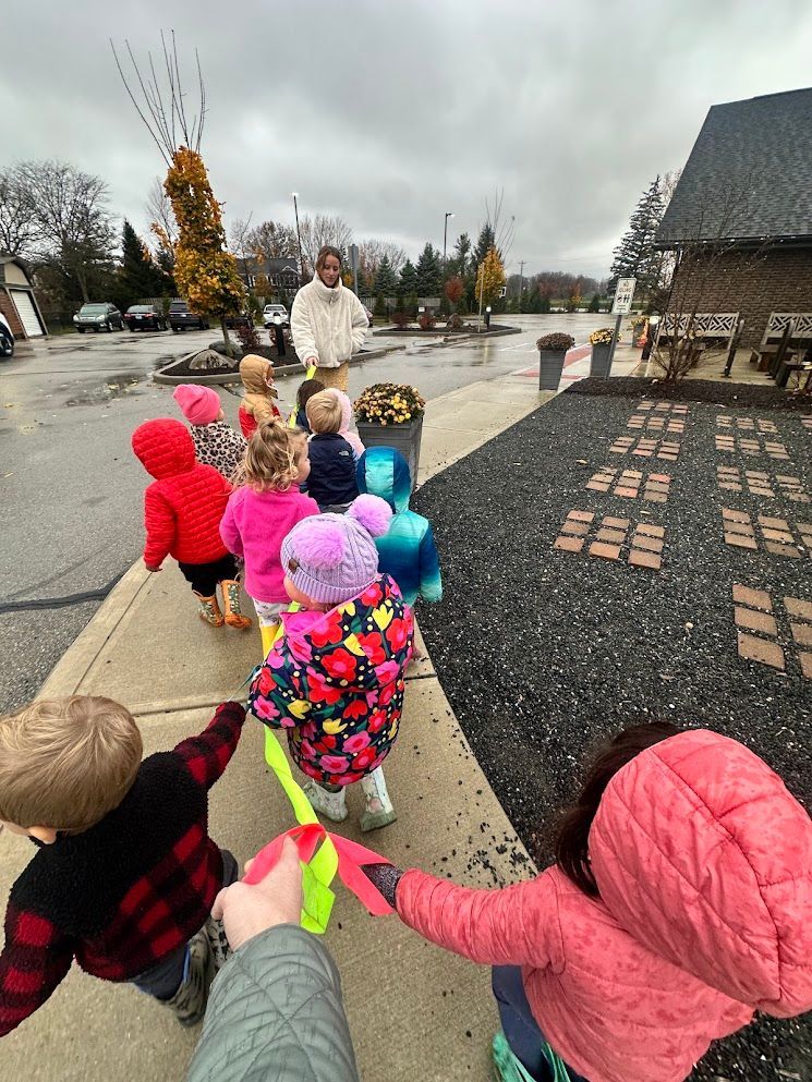 The IMA Toddler Community enjoys a walk outside. 