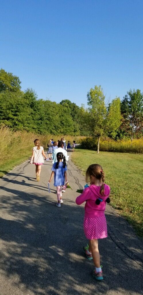 Montessori children take a walk in the park.