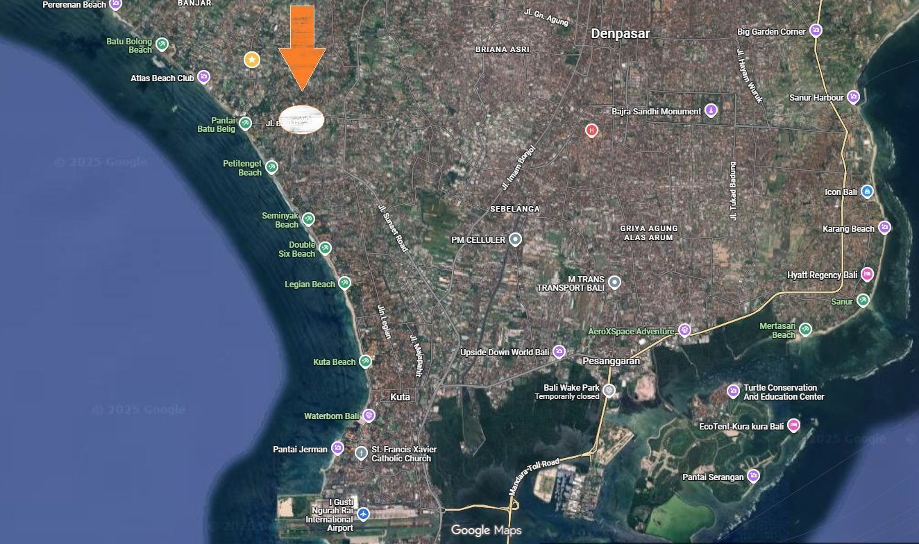 Satellite view of a coastal area, with an orange arrow and white oval indicating a location inland from the coast.