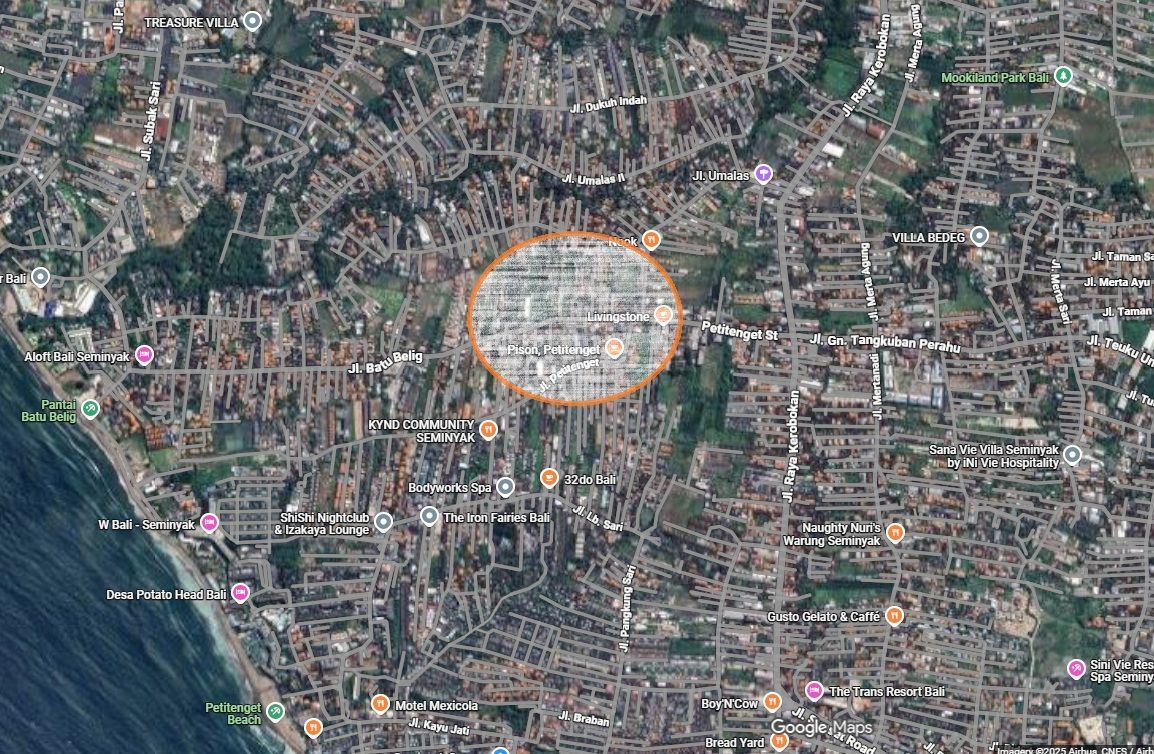Aerial view of a city with an orange circle highlighting a densely populated area.