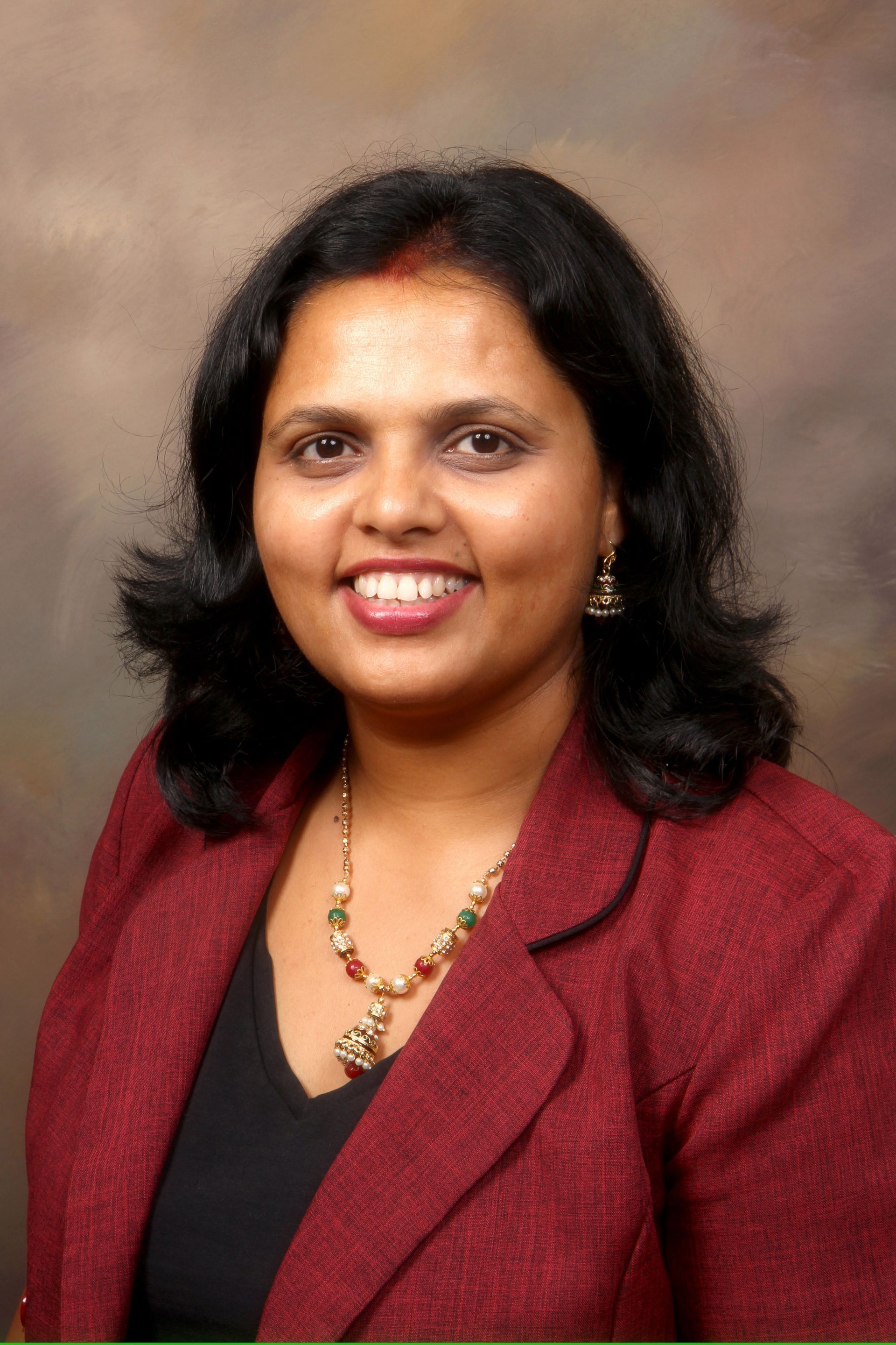 Woman in red blazer smiling