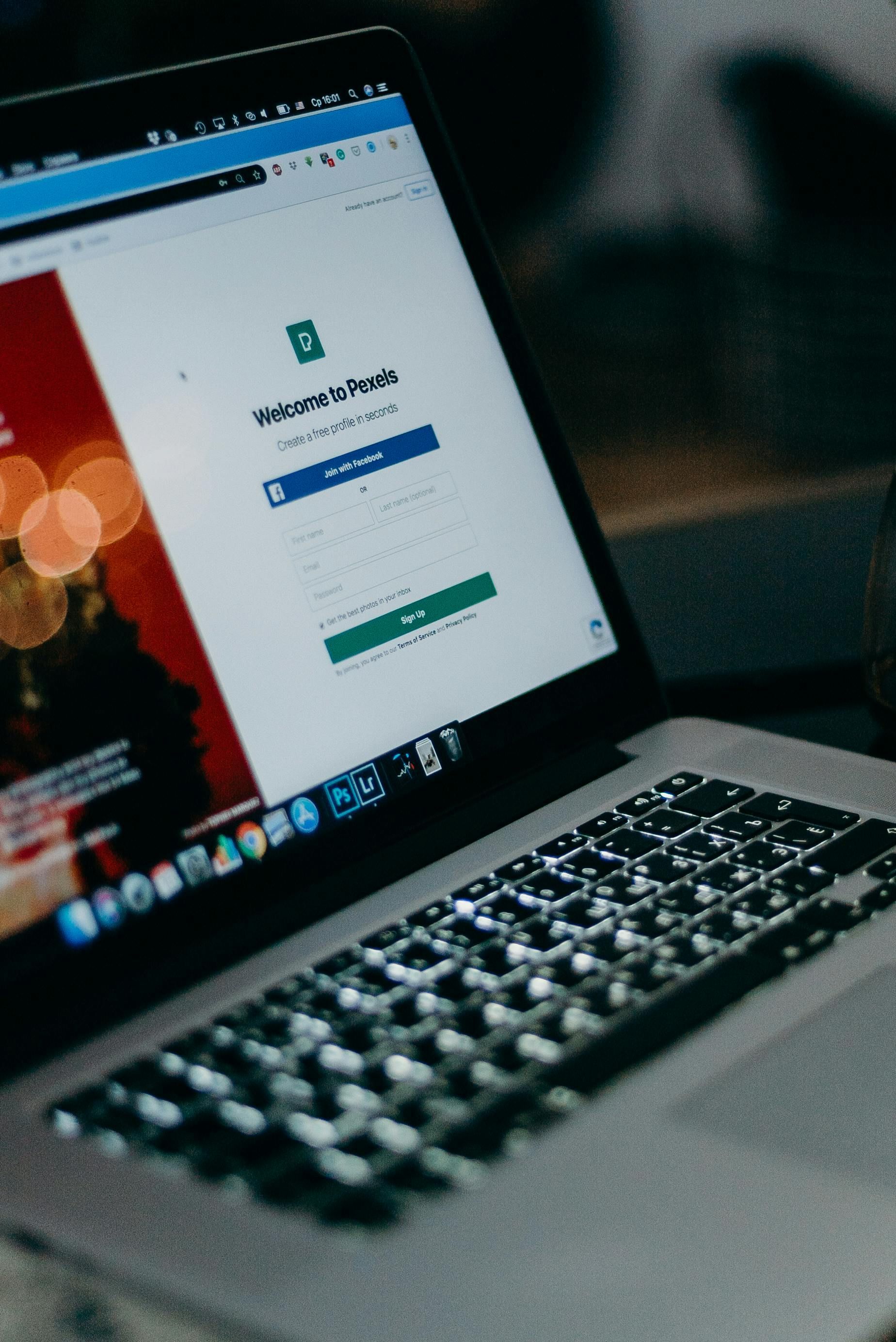 Laptop displaying a website with a login form; keyboard in focus.
