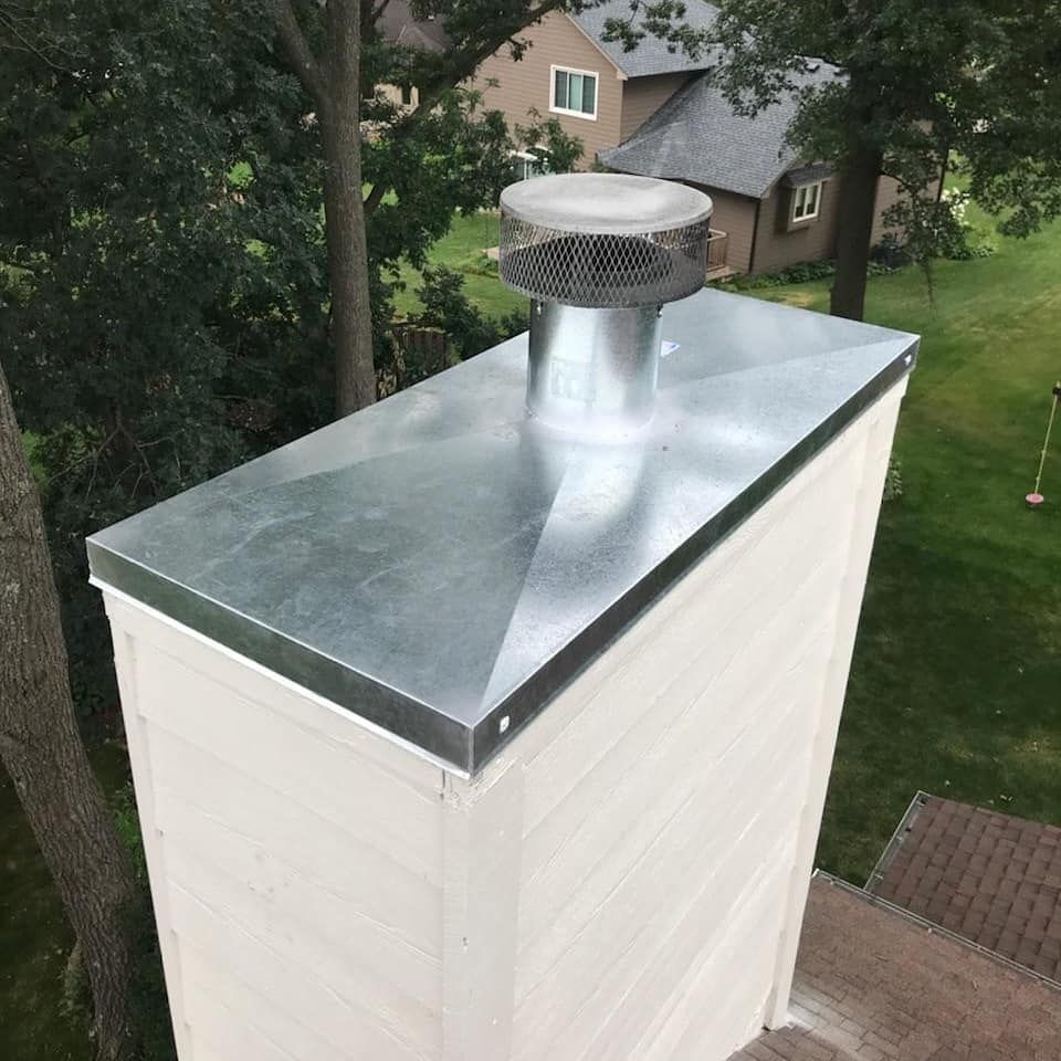 A chimney with a shovel sticking out of it.
