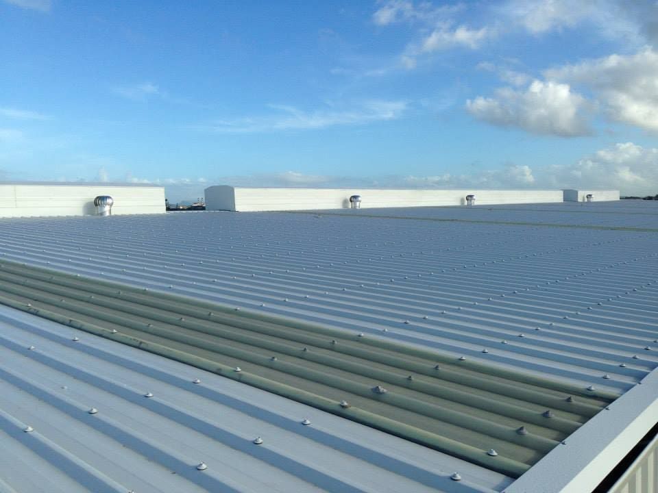 A White Roof With a Blue Sky in the Background — Reed Plumbing Industries in Airlie Beach, QLD