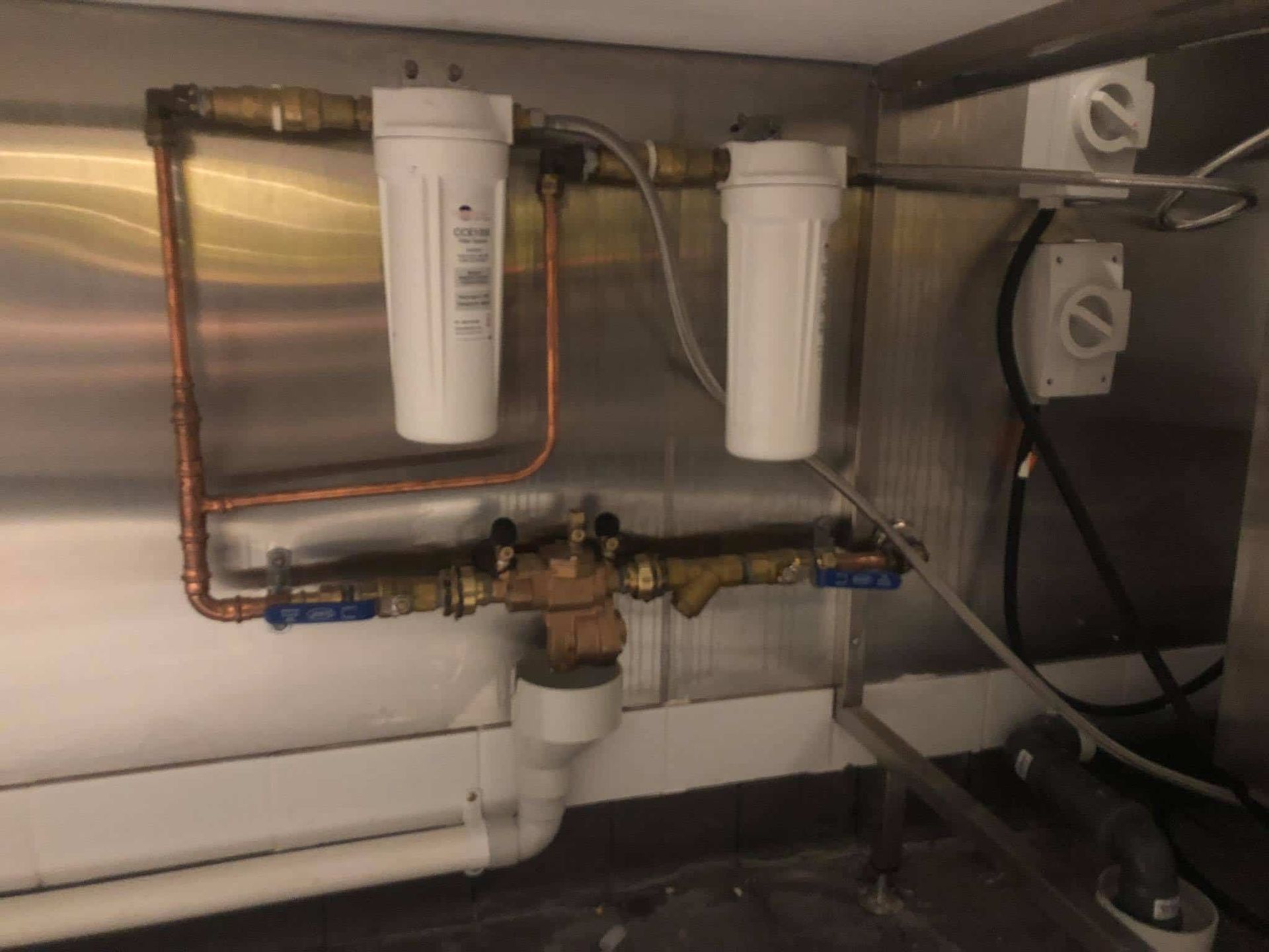A Close Up of a Kitchen Sink With a Water Filter — Reed Plumbing Industries in Andergrove, QLD
