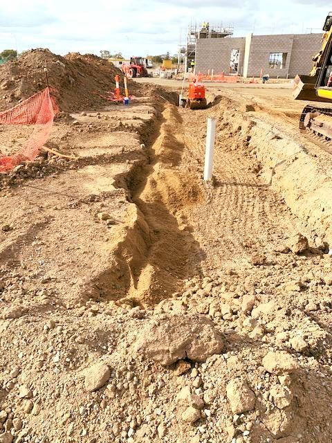 A Construction Site With a Pipe in the Middle of the Dirt — Reed Plumbing Industries in Mackay, QLD